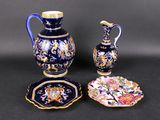 three pieces of blue and gold vases and a plate