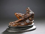 une image représentant une sculpture d'un homme allongé sur un socle en marbre
