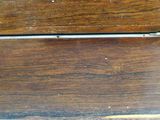 a close up view of a wooden bench with peeling paint
