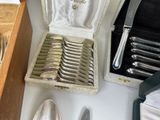 a lot of silverware in a box on a table