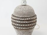 a white vase with a brown stripe on it