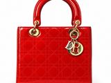a close up of a red handbag on a white background