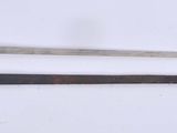 two swords that are laying next to each other on a table
