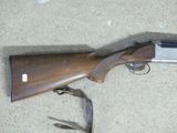 the rifle is laying on the floor next to a lanyard