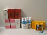 several boxes of skin care products sitting on a white surface