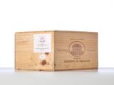 a wooden box with a label on it sitting on a table