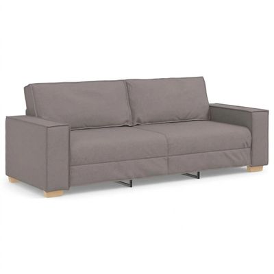 a gray couch sitting on top of a white floor next to a white wall