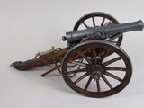 a toy cannon sitting on top of a wooden cart