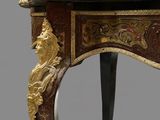 a small table with a marble top on a grey background