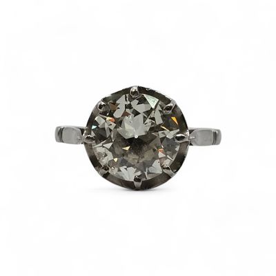 a close up of a diamond ring on a white background