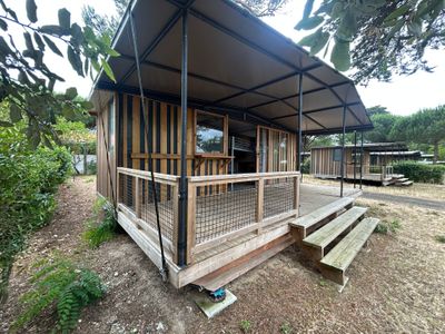 a small wooden house with a porch and a covered porch
