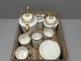 a box with a variety of white and gold dishes