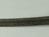 a knife that is laying on a white surface
