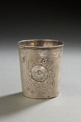a silver cup that is sitting on a table