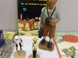 a small figurine of a man with a camera on a table