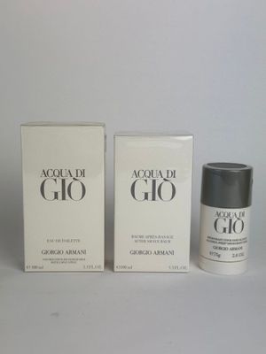 two boxes of perfume sitting next to each other on a table