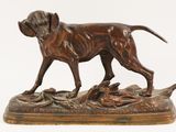 bronze statue of a dog with a duck in its mouth on a wooden base