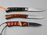 three different types of knives are lined up on a table