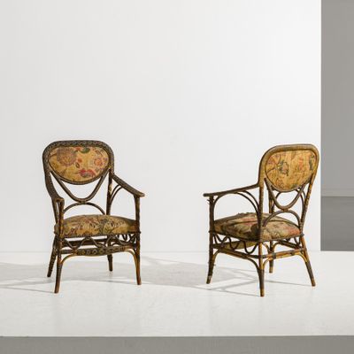 two chairs with floral upholstered cushions in a white room