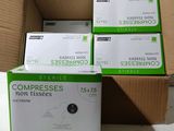 three boxes of compressses are stacked on top of each other