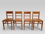trois chaises en bois assises l'une à côté de l'autre sur une surface blanche