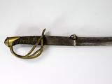 a close up of a sword on a white surface