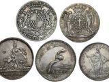 four silver coins with the arms of two men and two women on them