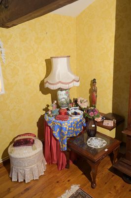 un salon avec une horloge et une table sur laquelle se trouve une lampe