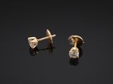a pair of gold and diamond earrings