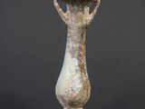 an old stone vase sitting on top of a table next to a black background