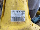 a close up of a yellow fire hydrant with a sticker on it