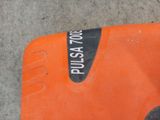 a close up of an orange and black electric drill on a concrete floor