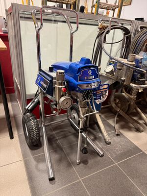 a picture of a small airless paint sprayer in a garage