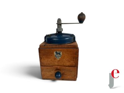 a small wooden grinder with a blue lid