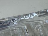 a close up of a car ' s headlight with a sticker on it