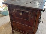 an old stove that is sitting in the middle of a room