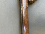 a close up of a cane with a wooden handle on a table