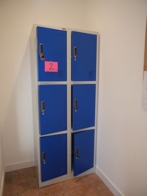 two blue lockers in the corner of a room