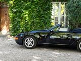 an image of a black sports car parked in front of a house
