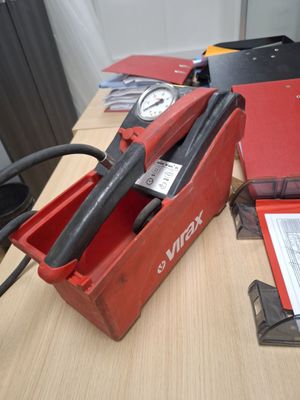 a red box with a tool in it sitting on a table