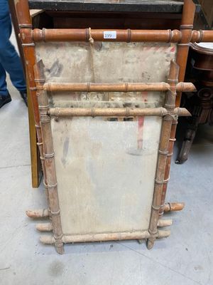 a tall wooden frame with a mirror on top of it