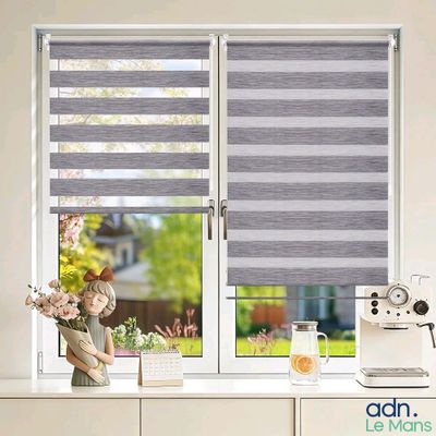 a window with a grey and white striped blind in front of a window