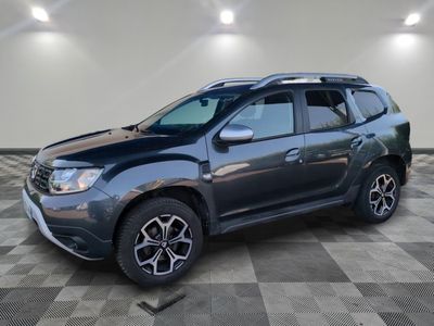a grey dacia is parked in a room with a checkered floor