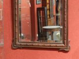 a mirror hanging on the wall in a room