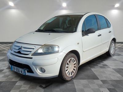 a picture of a small white car parked in a garage