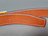 a close up of a pair of leather belts on a table