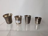 three silver cups sitting on top of a glass table