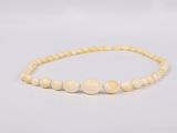 a close up of a beaded bracelet on a white background