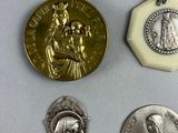 three silver and gold medals and a medal on a white surface