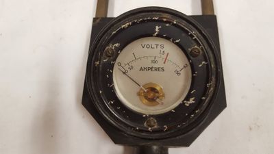 a close up of a gauge on a white surface